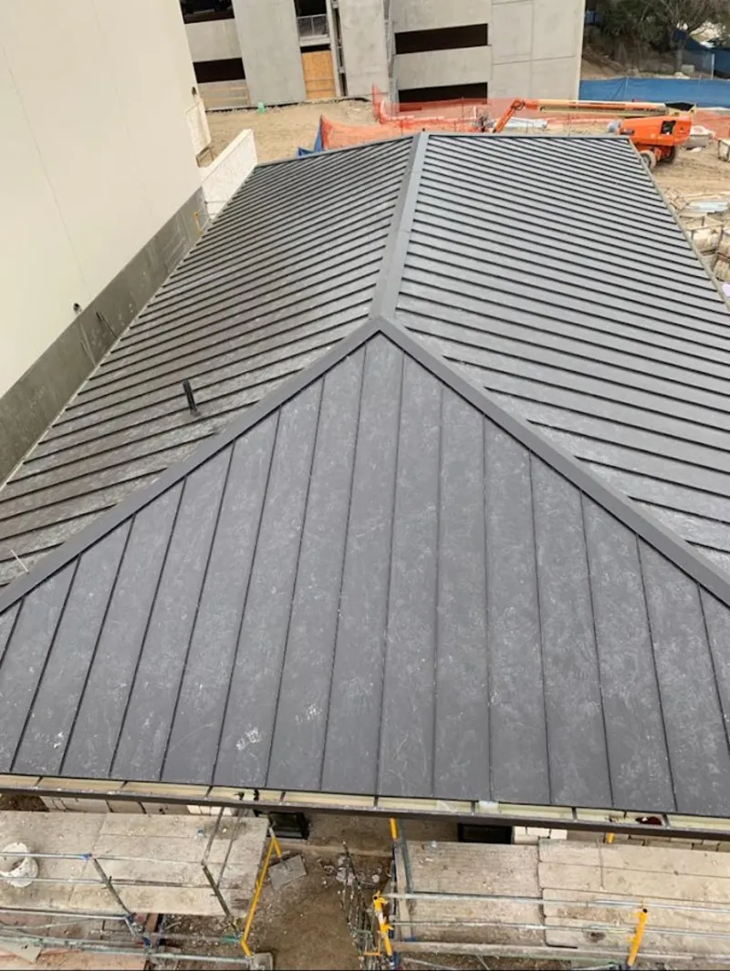 Commercial metal roof construction with crane equipment in Catonsville